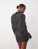 Noughts & Kisses Chiffon High Neck Shoulder Pad Blouson Mini Dress In Black Polka Dot