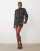 Noughts & Kisses Chiffon High Neck Shoulder Pad Blouson Mini Dress In Black Polka Dot